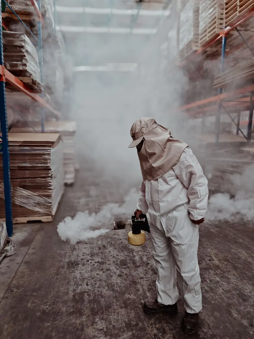 Technician treating a warehouse